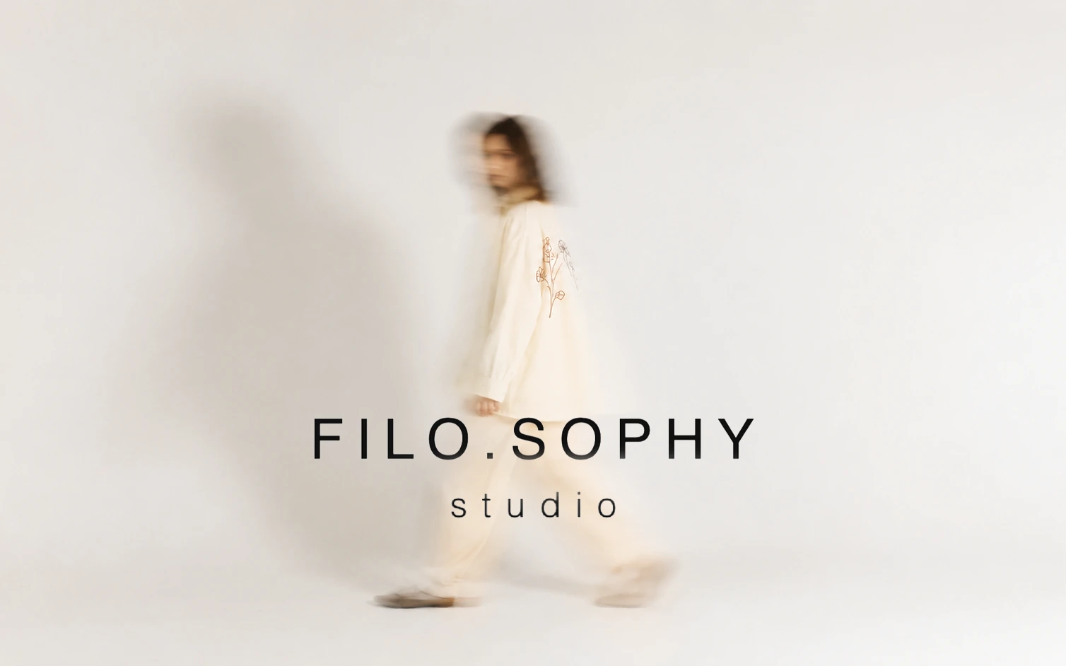 Filo.sophy Studio — walking model wearing embroidered garment